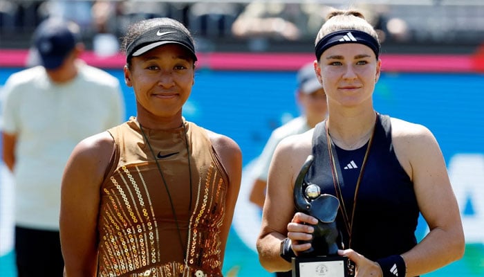 Czech Republics Karolina Muchova holds aloft the trophy alongside Japans Naomi Osaka as she celebrates winning their final match.—Reuters