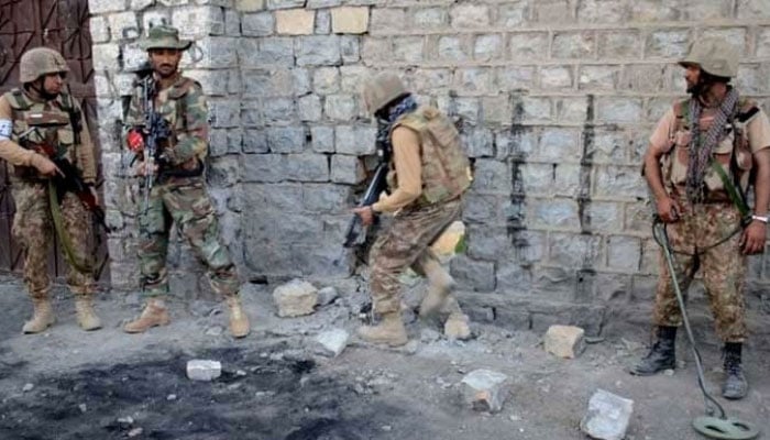 In this  photo, security forces are seen taking position during an operation. — ISPR/File