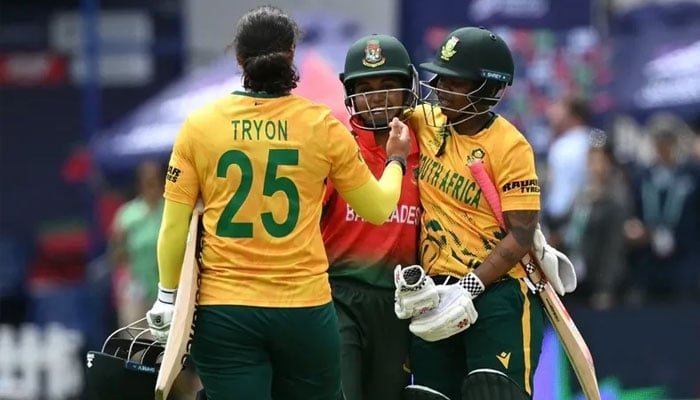 SAs Chloe Tryon (left) and Sinalo Jafta (right) console Bangladeshs captain Nigar Sultana after the ICC Womens T20 cricket world cup 2026 game in London.—AFP