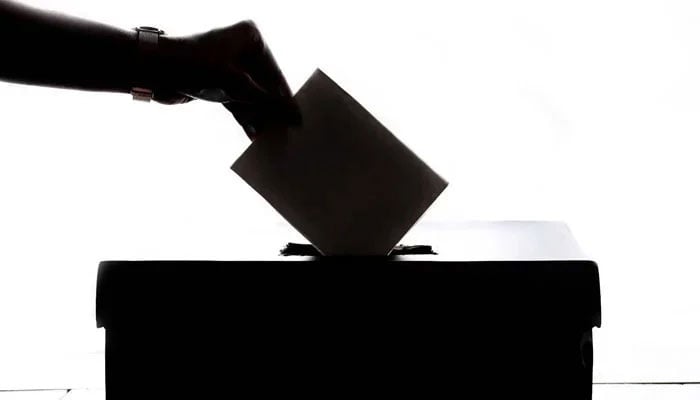 A representational image o a person casting a ballot. — Unsplash/File