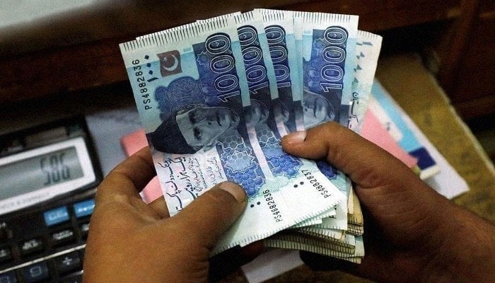 The image shows several 1000 Pakistani Rupee (PKR) banknotes. — Reuters/File