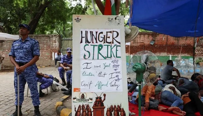 A security officer from the Rapid Action Force (RAF) stands next to a sign which reads “Hunger Strike”, during a sit-in protest called by Cockroach Janta Party (CJP), demanding the resignation of Indian Education Minister Dharmendra Pradhan, at Jantar Mantar in New Delhi, India, June 30, 2026. — Reuters