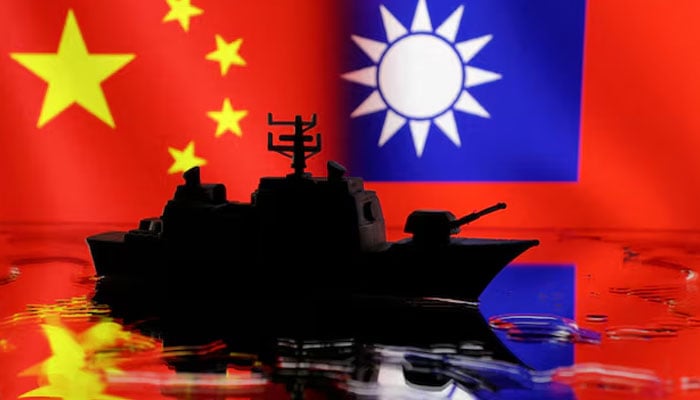 A Navy miniature is seen in front of displayed Chinese and Taiwanese flags in this illustration taken, April 11, 2023.—Reuters