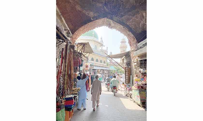 Entrance to the compound of Wazir Khan Mosque in the Walled City of Lahore, showing the narrow passage with shops all around.