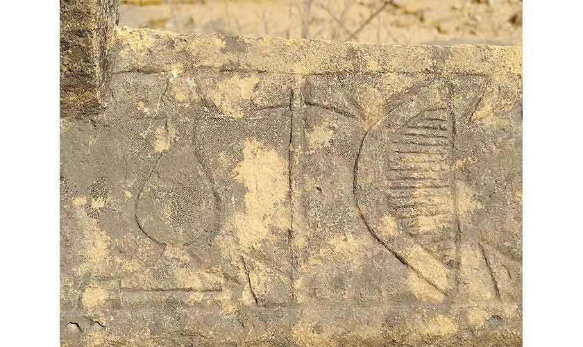 Carved comb and surma daani motifs on the grave.