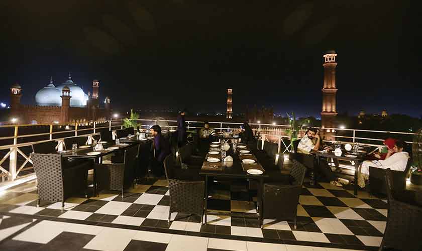 In the background of the rooftop of House Specialty Coffee, the Badshahi Masjid rises like the enormous red sandstone structure it’s always been, its three marble-clad domes held aloft by centuries of history, seemingly indifferent to the city unfolding around its perimeter. — Photos by Rahat Dar
