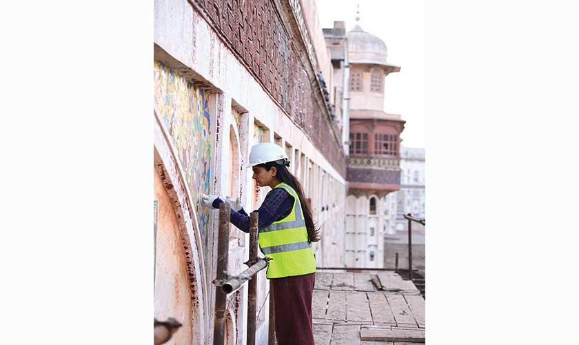 A cohort of young women conservation professionals stood on scaffoldings rising 60 feet or so above ground, braving Lahore’s extreme weather, devoted to the meticulous process of restoring different sections of the wall.