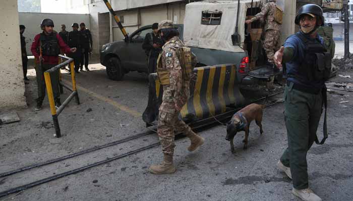 Paramilitary soldiers stand guard at the site after suicide bombers targeted the headquarters of the Federal Constabulary in Peshawar on November 24, 2025. — Reuters