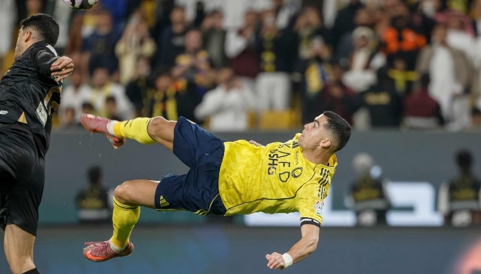 Nassrs Portuguese forward Cristiano Ronaldo (R) kicks the ball to score his teams fourth goal during the Saudi Pro League football match between Al-Nassr and Al-Khaleej at Al-Awwal Park in Riyadh on November 23, 2025. — AFP