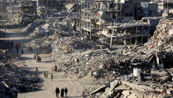 Palestinians walk past the rubble of houses and buildings destroyed during the war, following a ceasefire between Israel and Hamas, in Rafah in the southern Gaza Strip on January 20, 2025. — Reuters