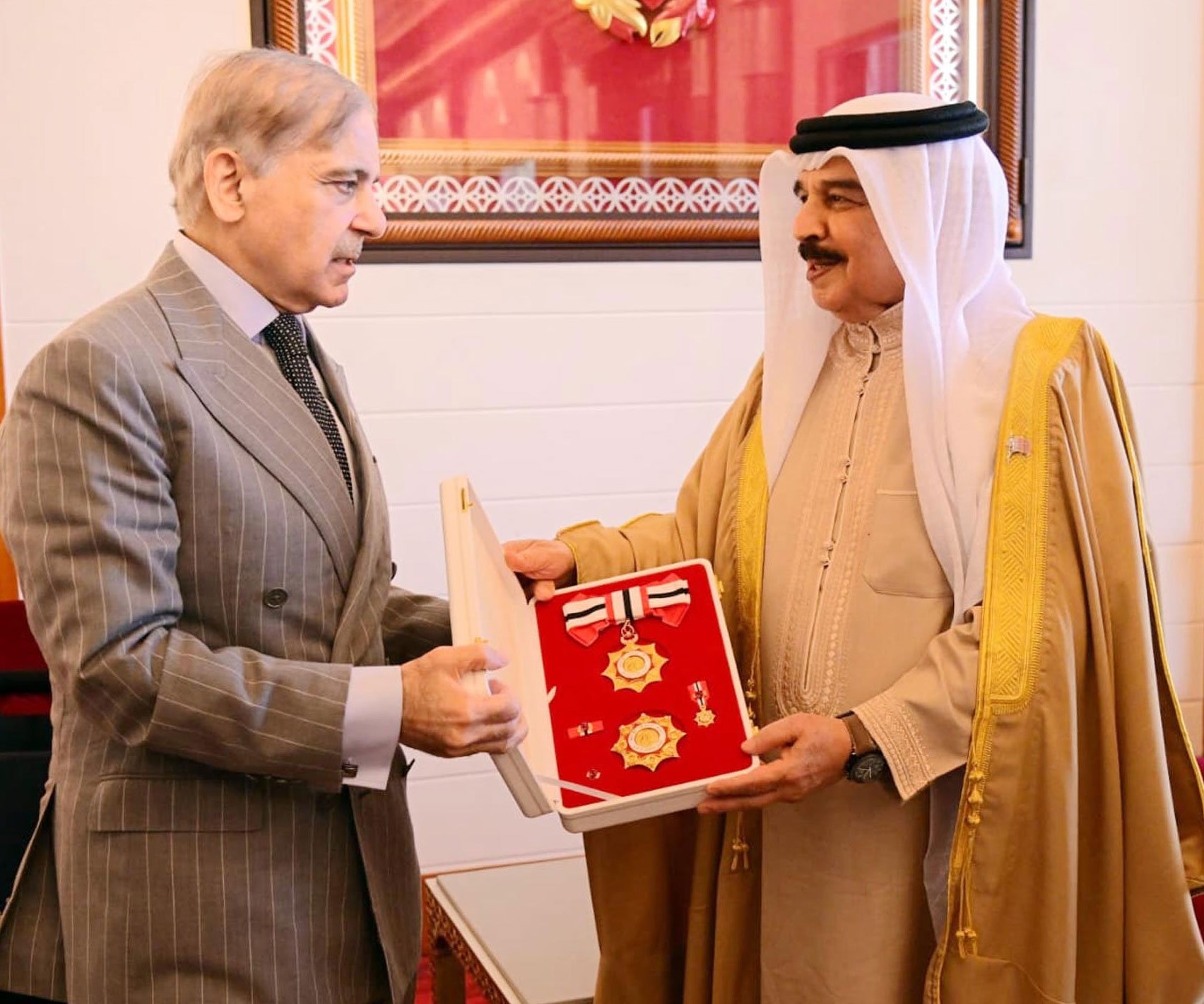 Bahrain’s King Hamad bin Isa Al-Khalifa (right) confers the Order of Bahrain (First Class) Upon Prime Minister Shehbaz Sharif in Manama on November 26, 2025. — PID