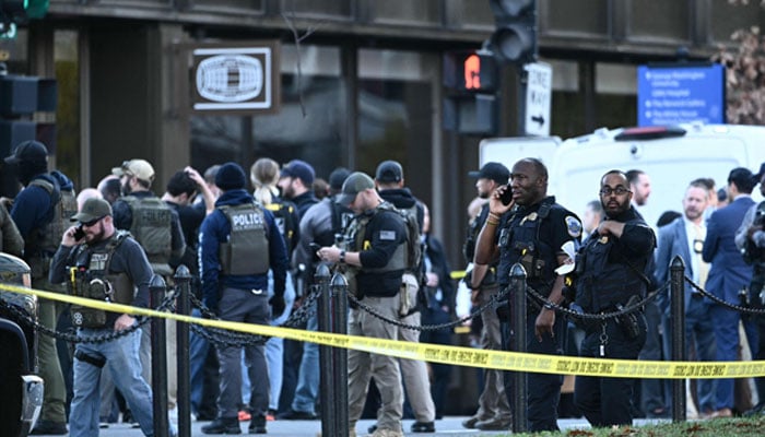 Law-enforcement officers secure the area after a shooting in downtown Washington, on November 26, 2025. — AFP