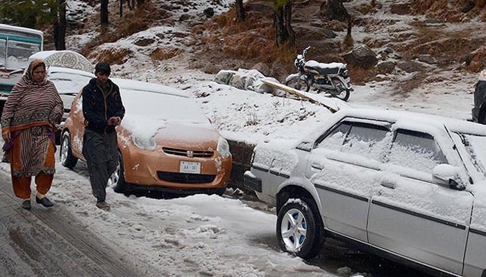 Representational image shows vehicles covered in snow in Murree. — INP/File