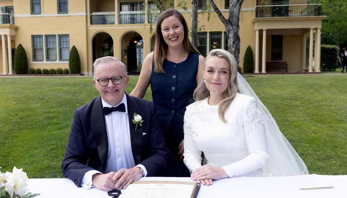 Australian Prime Minister Anthony Albanese (L) and his new wife Jodie Haydon (R) sign the marriage certificate with celebrant Bree during their wedding ceremony in Canberra on November 29, 2025.— AFP