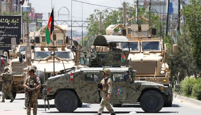 A frontier guard stands on a bridge to Afghanistan across Panj river in Panji Poyon border outpost, south of Dushanbe, Tajikistan, May 31, 2008. — Reuters