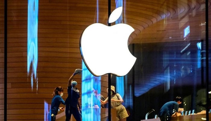 Customers visit an Apple store in this file photo. — AFP