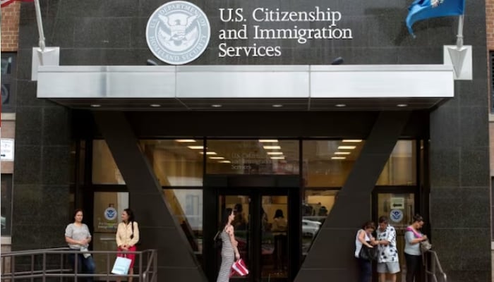 People stand on the steps of the US Citizenship and Immigration Services offices in New York, US on August 15, 2012. — Reuters