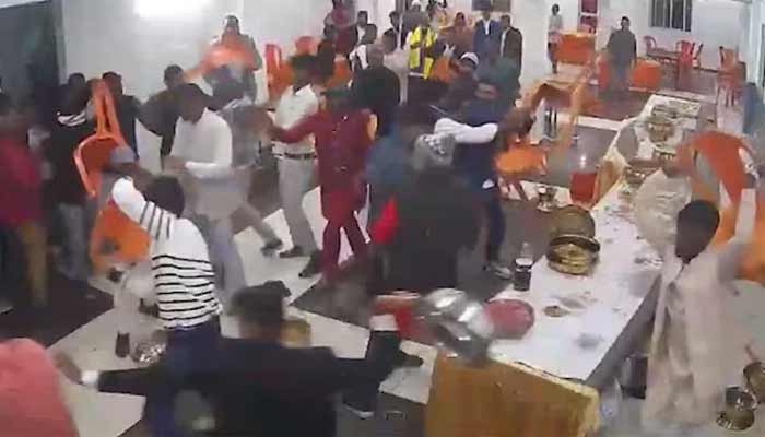 Attendees of wedding, gathered for the ceremony, can be seen fighting with each other in this screengrab. — Indian media