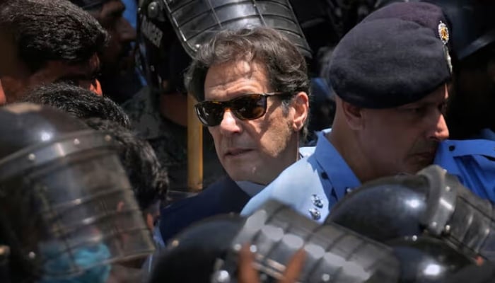Security officers escort Pakistan Tehreek-e-Insaf (PTI) founder Imran Khan as he appears in Islamabad High Court, Pakistan May 12, 2023. — Reuters