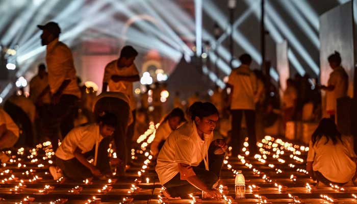 People light diyas at the India Gate memorial as part of the Diwali celebrations, the Hindu festival of lights, at Kartavya Path in New Delhi on October 18, 2025. — AFP