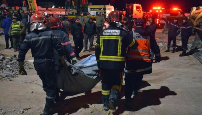 Rescue workers move a body recovered from the site of building collapse in Fes, Morocco. — AFP