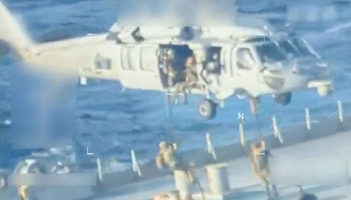 US forces abseil onto an oil tanker during a raid described by US Attorney General Pam Bondi as its seizure by the United States off the coast of Venezuela, December 10, 2025, in a still image from video. — Reuters