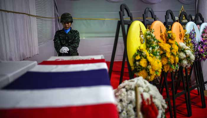 A soldier salutes next to a coffin of Sergeant Major Ananda Udon, 39, a Thai soldier who died on December 10 amid clashes between Thailand and Cambodia along a disputed border area, during his funeral at a temple in Si Sa Ket province, Thailand, December 12, 2025. — Reuters