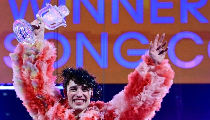 Swiss singer Nemo representing Switzerland with the song The Code celebrates on stage with his trophy after winning the final of the 68th Eurovision Song Contest (ESC) 2024 on May 11, 2024, at the Malmo Arena in Malmo, Sweden. — AFP