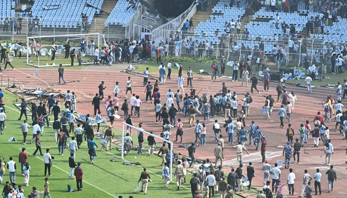 Security personnel try to control the crowd as Inter Miami’s Argentine forward #10 Lionel Messi departs from the Salt Lake Stadium in Kolkata on December 13, 2025. — AFP