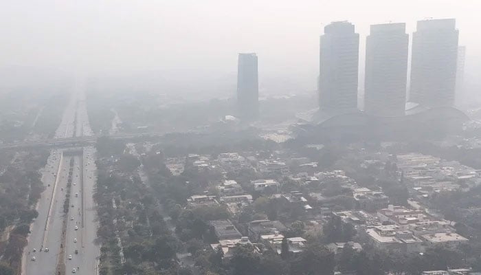 An aerial photograph shows buildings engulfed in dense smog in Islamabad on December 4, 2025. — AFP