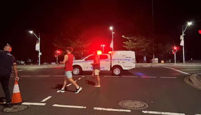 People walk at the scene of a shooting incident at Bondi Beach, Sydney, Australia, December 14, 2025. — Reuters