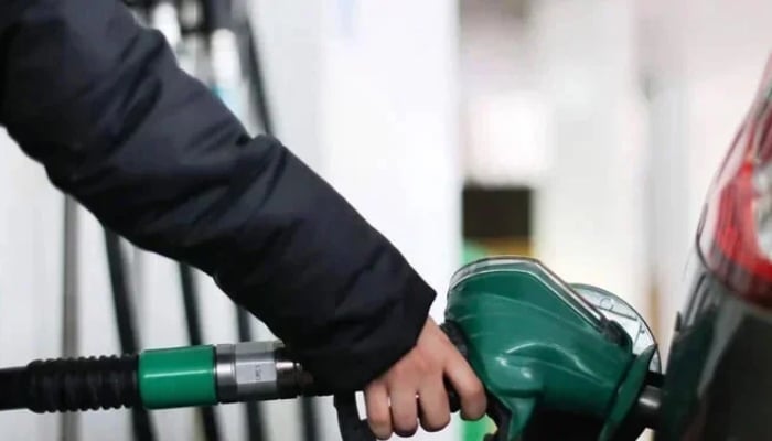 A person fills their cars tank at a fuel station in this undated image. — AFP/File