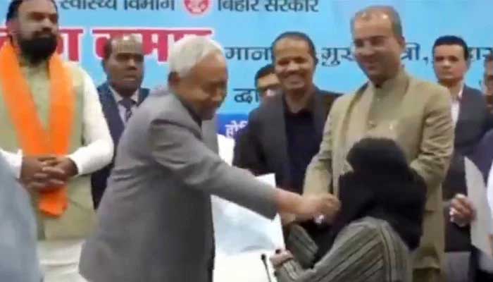 Bihar Chief Minister Nitish Kumar removes hijab of a newly recruited doctor during an official event on December 15, 2025. — Screengrab via X/@SouthAsiaIndex