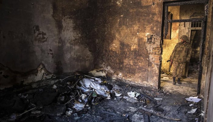 An army soldier stands in the Army Public School, which was attacked by militants in Peshawar on December 17, 2014. — Reuters