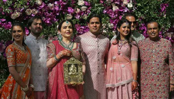 (Left to right) Radhika Merchant, Anant Ambani, Nita Ambani, Akash Ambani, Isha Piramal, Anand Piramal and Mukesh Ambani, the Chairman of Reliance Industries, pose during a photo opportunity at the wedding ceremony of Akash, at Bandra-Kurla Complex in Mumbai, India, March 9, 2019. — Reuters