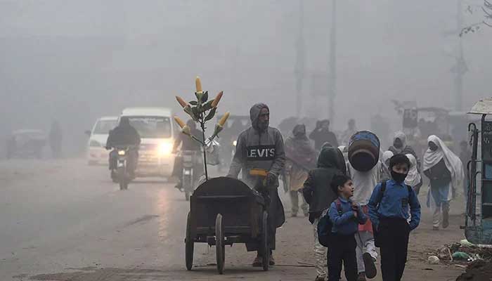 Children walk to school in cold weather in this undated image. — AFP/File