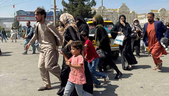 People try to get into Hamid Karzai International Airport in Kabul, Afghanistan, August 16, 2021. — Reuters
