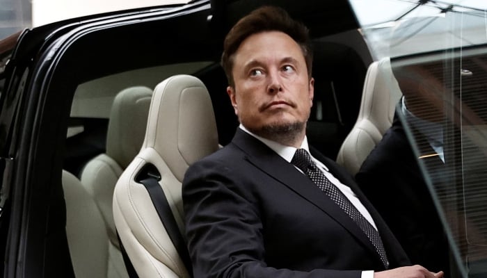Elon Musk gets in a Tesla car as he leaves a hotel in Beijing, China, May 31, 2023. — Reuters