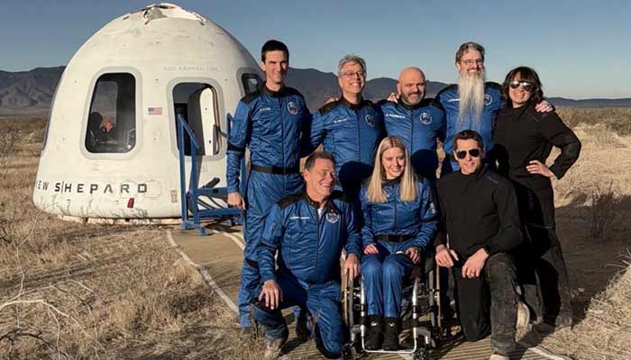 A German with spinal cord injury sitting in a wheelchair (centre) with other crews around her in front of the New Shepard spaceship ahead of departing for a space ride. — X/@davill