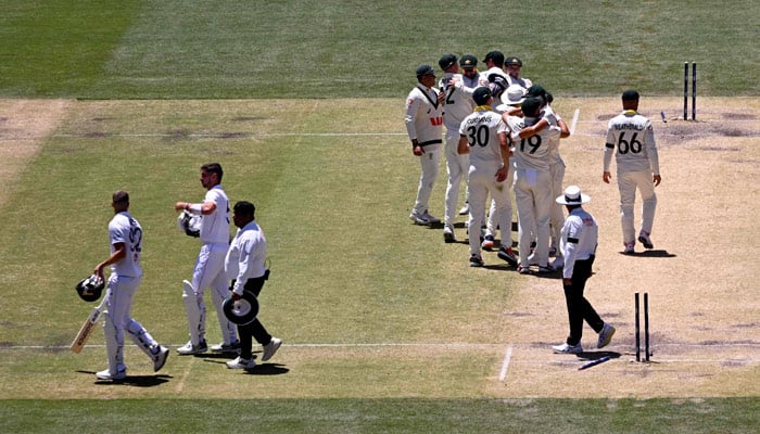 Australia´s Mitchell Starc (right) celebrates dismissing England batsman Jamie Smith (left) on the final day of the third Ashes cricket Test match between Australia and England at the Adelaide Oval in Adelaide on December 21, 2025. — AFP