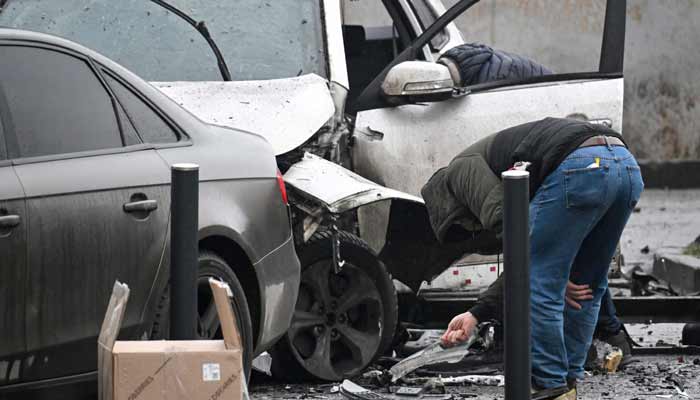 Investigators work at the car blast site in southern Moscow on December 22, 2025.— AFP