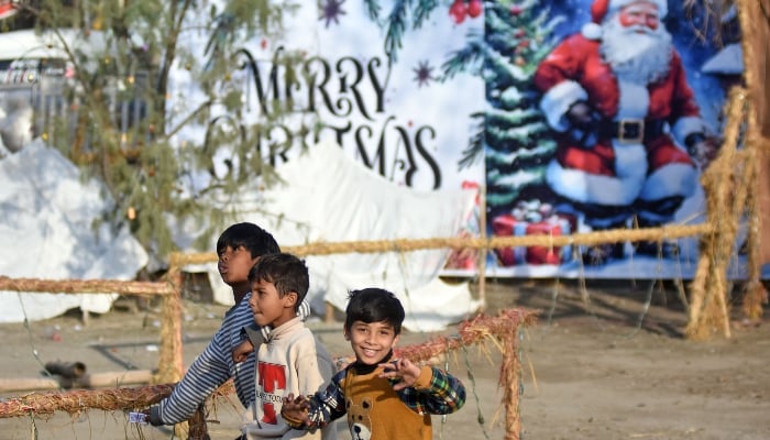 Christian children are at F-6 Katchi Abadi, on the eve of the Christmas celebration, in Islamabad. — ONLINE