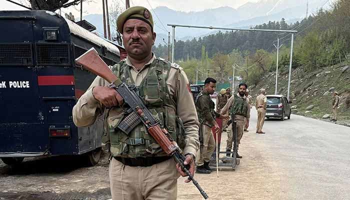 Indian police officers stand guard at a check point following a suspected attack, near Pahalgam in IIOJKs Anantnag district, April 22, 2025. — Reuters