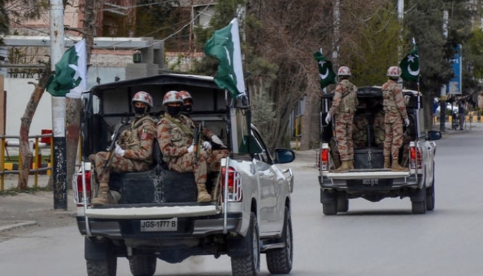 Security personnel patrol with vehicles on a street in Quetta. — AFP/File
