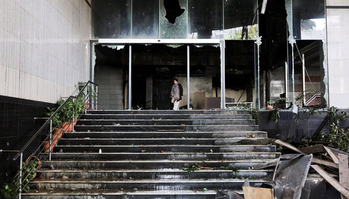 A woman walks at the vandalised basement of the Daily Star building, following the death of Sharif Osman Hadi, a student leader, who had been undergoing treatment in Singapore after being shot in the head, in Dhaka, Bangladesh, December 19, 2025. — Reuters