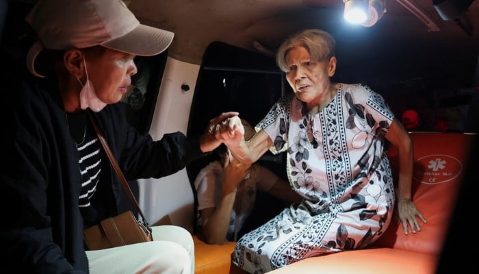 Local people rescue an elderly woman during a fire at Werdha Damai retirement home in Manado, North Sulawesi Province, Indonesia, December 28, 2025. — Reuters
