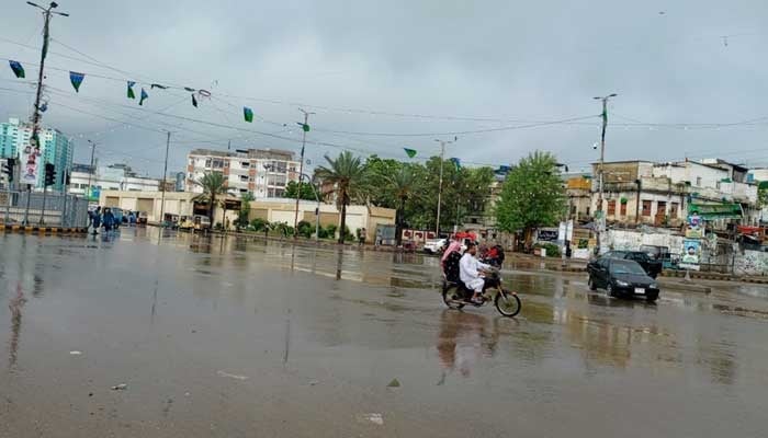 Commuters pass through Karachis Numaish Chowrangi after early morning showers on September 10, 2025. — Geo.tv