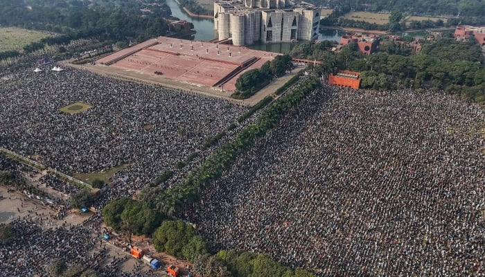 An aerial view shows mourners gathered for the funeral prayer of Bangladeshs former prime minister Khaleda Zia at the Parliament House premises in Dhaka, December 31, 2025. — AFP