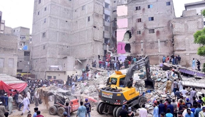 Heavy machinery is deployed for rescue operations after a residential building collapsed in Baghdadi, Lyari on July 4, 2025. — APP