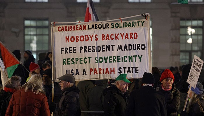 Demonstrators hold placards during a protest against US strikes against Venezuela and the capture of Venezuelan President Nicolas Maduro, in London, Britain, January 5, 2026. — Reuters